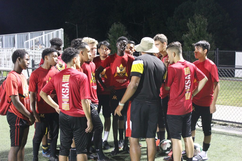 Bruno Kalonji talking with players